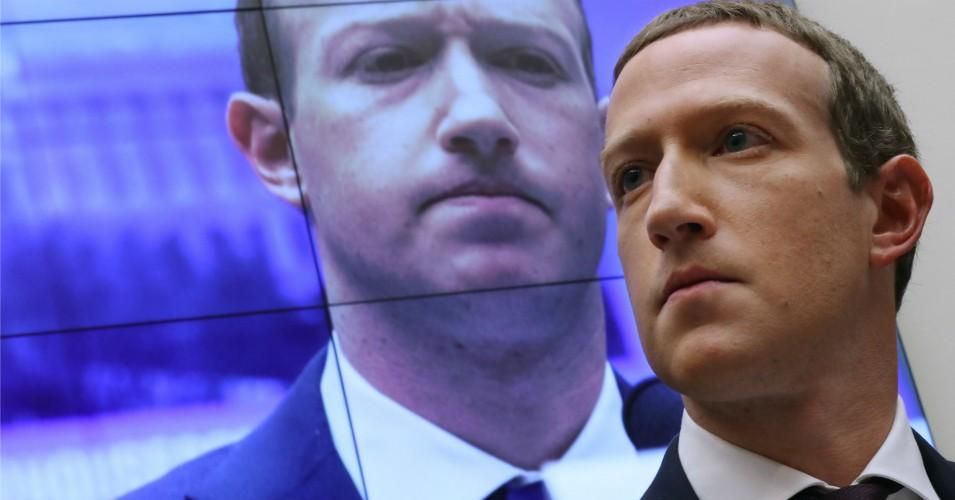 With an image of himself on a screen in the background, Facebook co-founder and CEO Mark Zuckerberg testifies before the House Financial Services Committee in the Rayburn House Office Building on Capitol Hill October 23, 2019 in Washington, D.C.