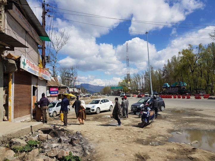 Residents line up outside a medicine shop in Indian-administered Kashmir. (Photo: Bilal Hussain)