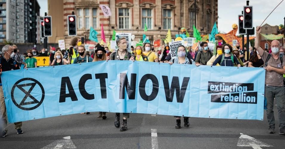 Protesters march with a banner during a demonstration in Manchester, United Kingdom on September 1, 2020.