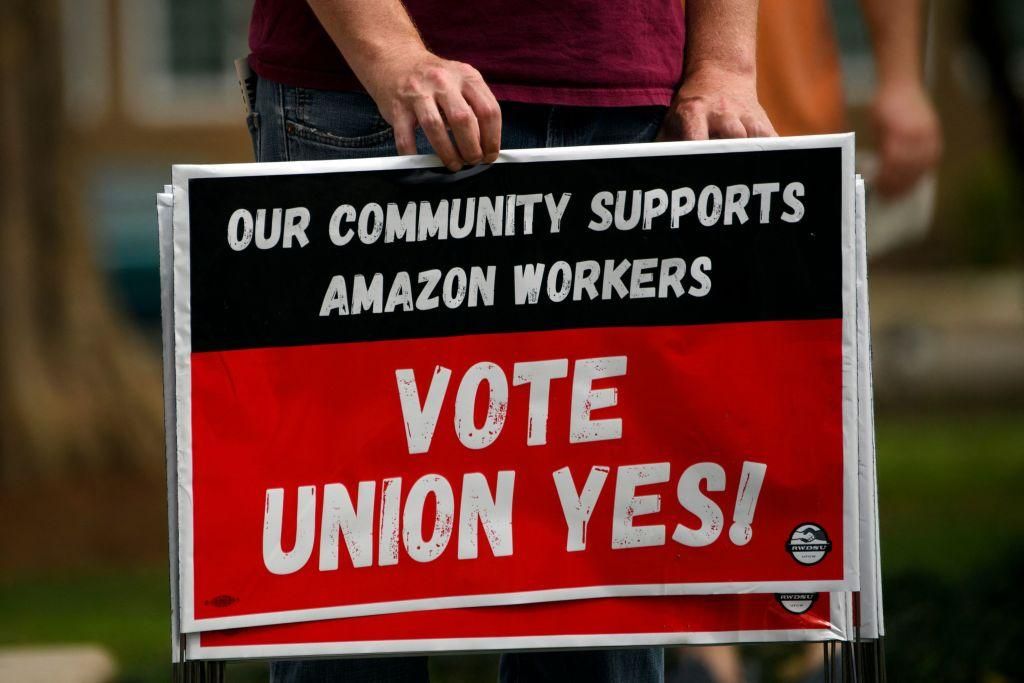 A person holds "Vote Union Yes!" signs during a protest in solidarity with Black Lives Matter, Stop Asian Hate and the unionization of Amazon.com, Inc. fulfillment center workers at Kelly Ingram Park on March 27, 2021 in Birmingham, Alabama. (Photo: PATRICK T. FALLON/AFP via Getty Images)