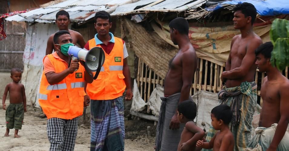 A Cyclone Preparedness Programme (CPP) volunteer uses a megaphone to urge residents to evacuate to shelters ahead of the expected landfall of Cyclone Amphan in Khulna on May 19, 2020.