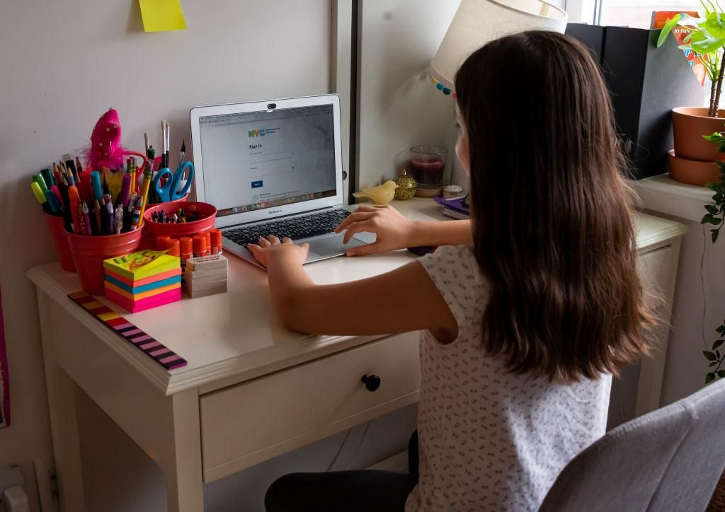 A kid sits in front of her computer as she does homeschooling at her home as the city continues Phase 4 of re-opening following restrictions imposed to slow the spread of coronavirus on September 27, 2020 in New York City. (Photo by Noam Galai/Getty Images)
