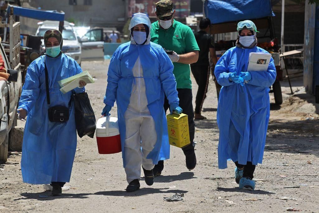 Iraqi medics arrive at the capital Baghdad's suburb of Sadr City on May 21, 2020, to test residents for COVID-19, as part of measures taken by the authorities aimed at containing the spread of the novel coronavirus. (Photo by AHMAD AL-RUBAYE/AFP via Getty Images)