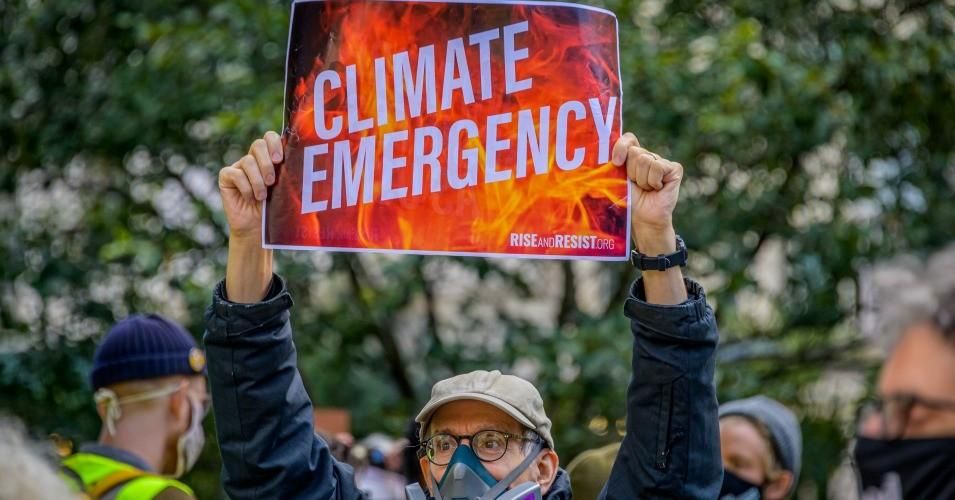 A participant holding a sign at the climate march. A coalition of climate, Indigenous and racial justice groups gathered at Columbus Circle to kick off Climate Week with the Climate Justice Through Racial Justice march.