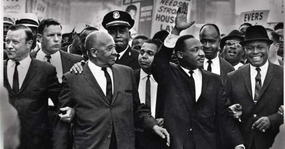 The Rev. Martin Luther King Jr. waves to onlookers while leading the 125,000 strong 'Walk to Freedom' on Woodward Avenue in Detroit in 1963.