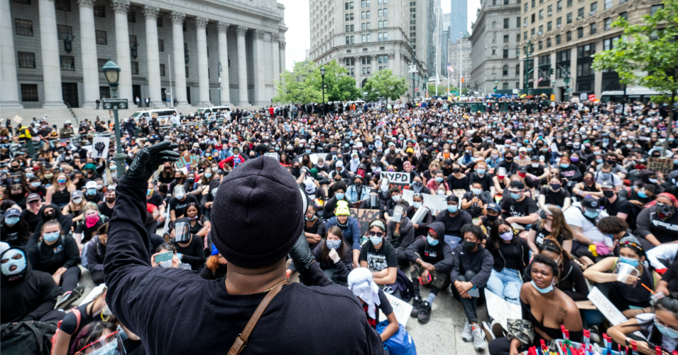 A massive group of protesters sit on the ground at Foley Square in a show of peaceful protest while they listen to a speaker. Protesters took to the streets across America after the killing of George Floyd at the hands of a white police officer Derek Chauvin that was kneeling on his neck during his arrest as he pleaded that he couldn't breathe. (Photo: Ira L. Black/Corbis via Getty Images)