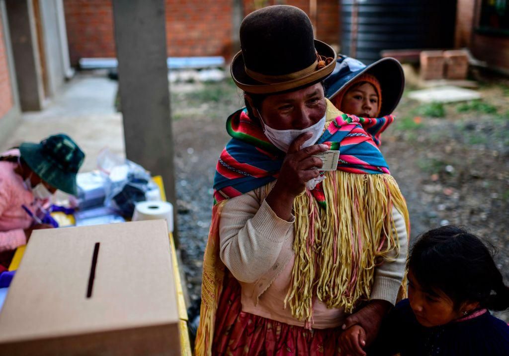 An indigenous woman votes at a polling station in Huarina, Bolivia, on October 18, 2020 during the country's general election. - Landlocked Bolivia elects a new president on Sunday after a 2019 poll was annulled and follow-up elections postponed twice amid the COVID-19 novel coronavirus pandemic. (Photo by RONALDO SCHEMIDT/AFP via Getty Images)