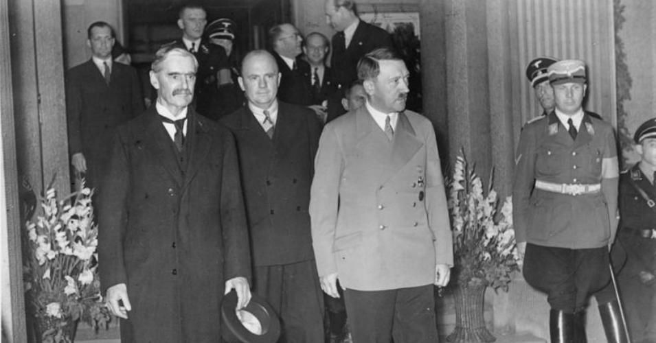 British Prime Minister Neville Chamberlain (left) and German Chancellor Adolf Hitler (in light jacket)