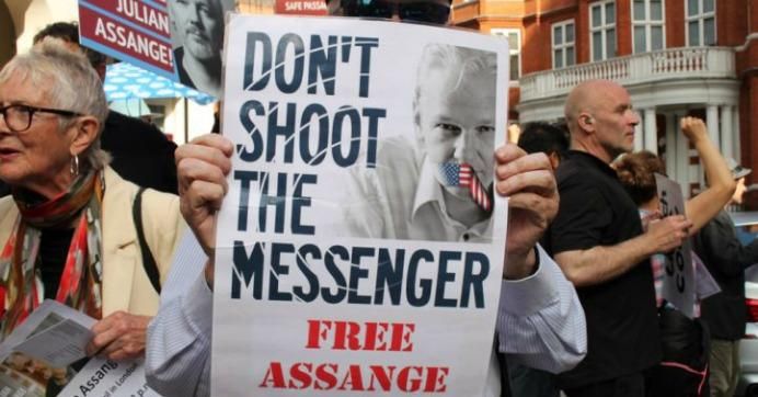 Sign reads: Don't shoot the messenger. Free Assange