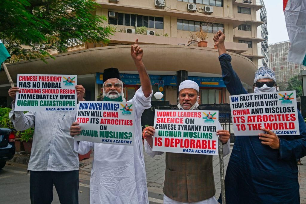 Muslims hold placards during a protest against the Chinese government's policies on Muslim Uighur minorities, in Mumbai on December 10, 2020. (Photo by INDRANIL MUKHERJEE/AFP via Getty Images)