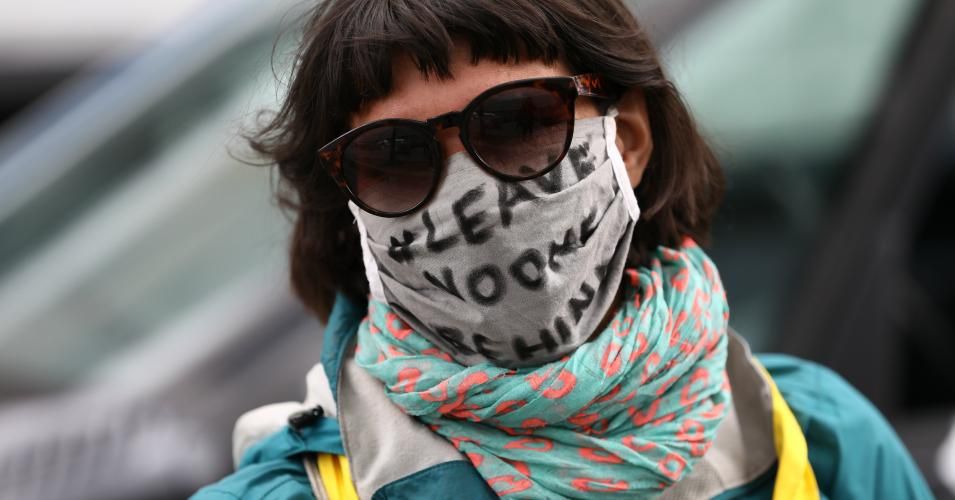 Protesters wearing protective face masks demonstrate while maintaining social distancing during the "MyGruni" Car parade on May Day during the novel coronavirus crisis on May 1, 2020 in Berlin, Germany. May Day protests are taking place across Germany today, though as gatherings are limited by authorities to a maximum of 20 people per gathering due to coronavirus lockdown measures, many small protests are taking place instead of traditional, large-scale marches. (Photo: Maja Hitij/Getty Images)