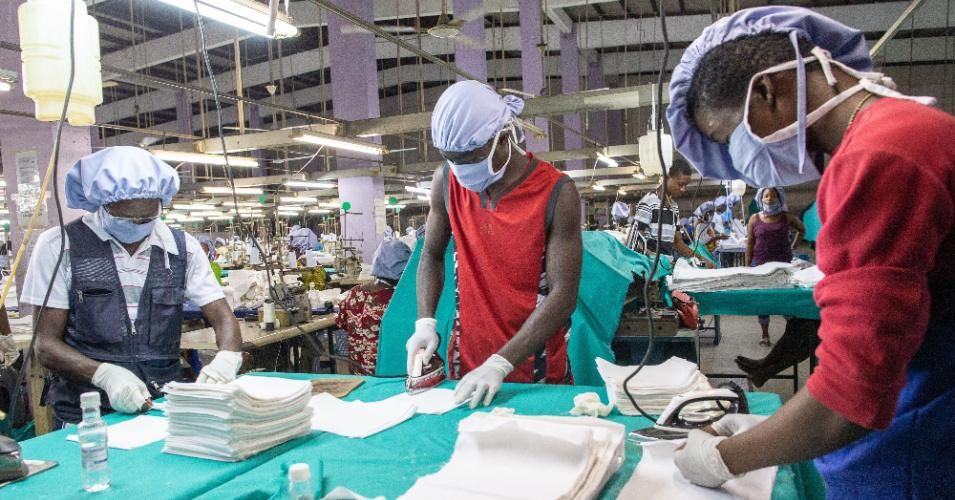Workers iron the fabric used for the production of personal protective equipment for COVID-19 coronavirus frontline health workers as commissioned by the government, in Accra, on April 17, 2020. (Photo: Nipah Dennis/AFP via Getty Images)