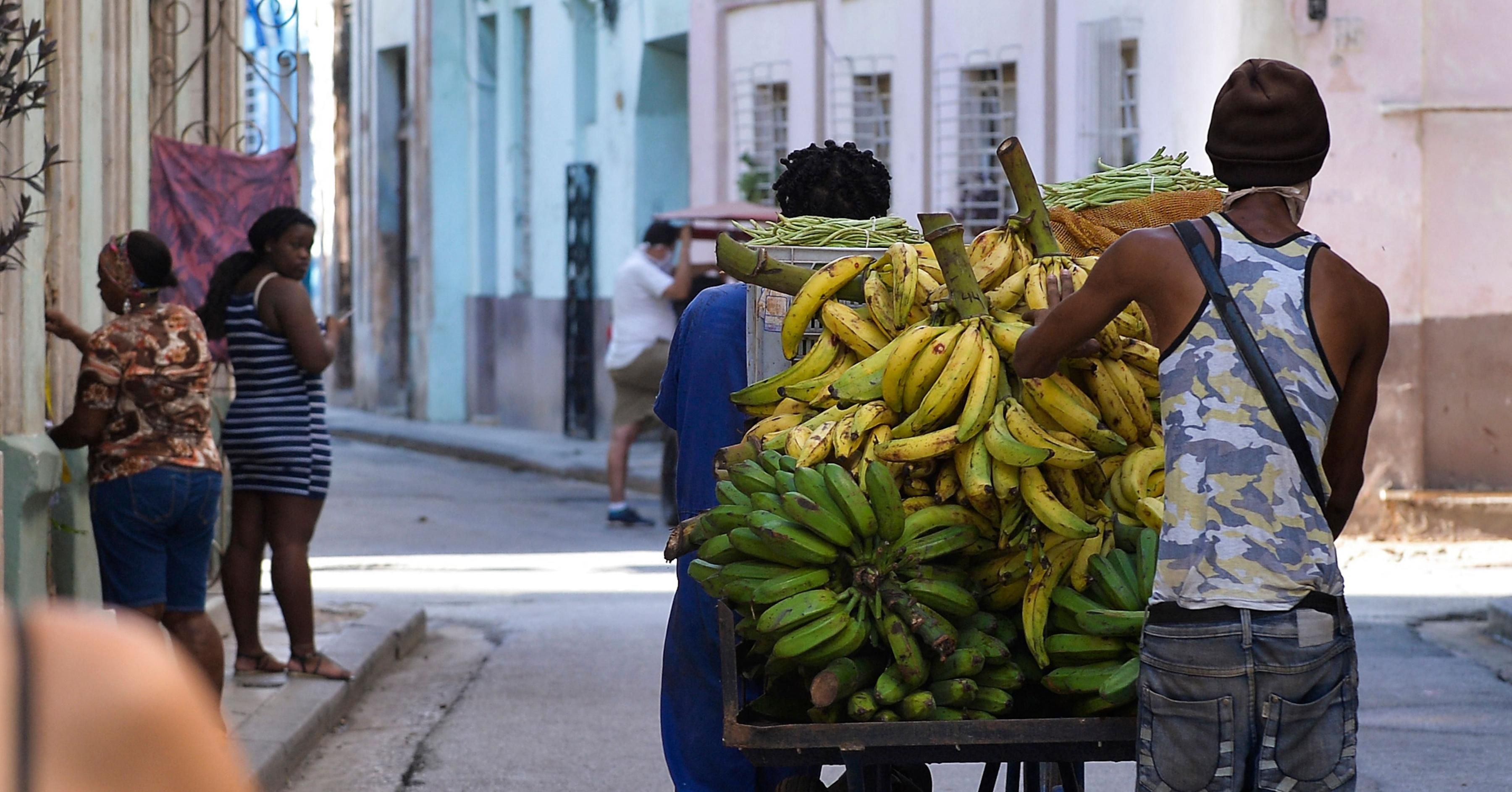 Men transport bananas for sale in Havana, on March 22, 2021. The Cuban economy is at its worst moment in almost 30 years, falling 11% in 2020, the biggest drop since 1993. (Photo: YAMIL LAGE/AFP via Getty Images)