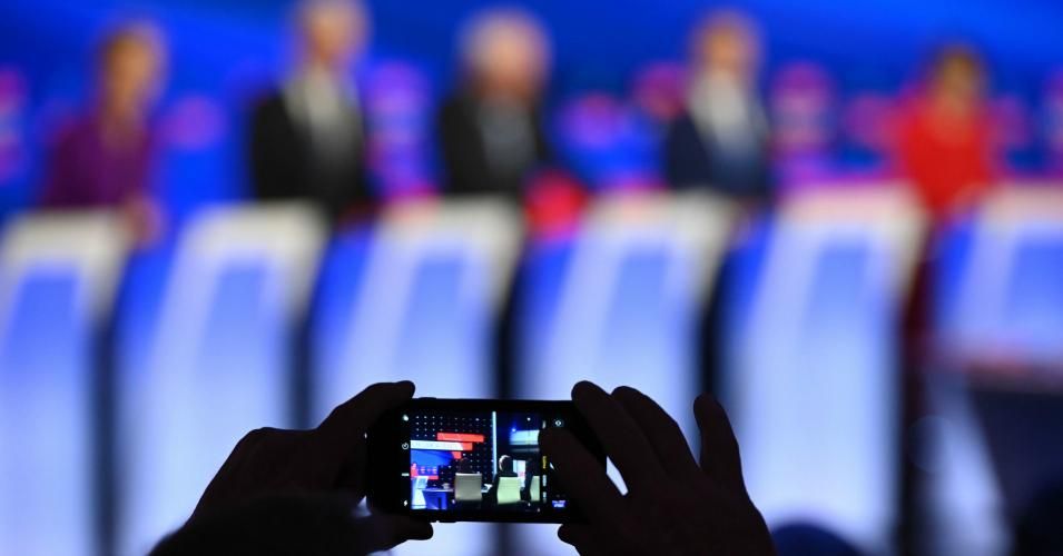 A member of the audience takes pictures of the Democratic presidential hopefuls during the seventh Democratic primary debate of the 2020 presidential campaign season co-hosted by CNN and the Des Moines Register at the Drake University campus in Des Moines, Iowa on January 14, 2020. (Photo: Robyn Beck/AFP/Getty Images)