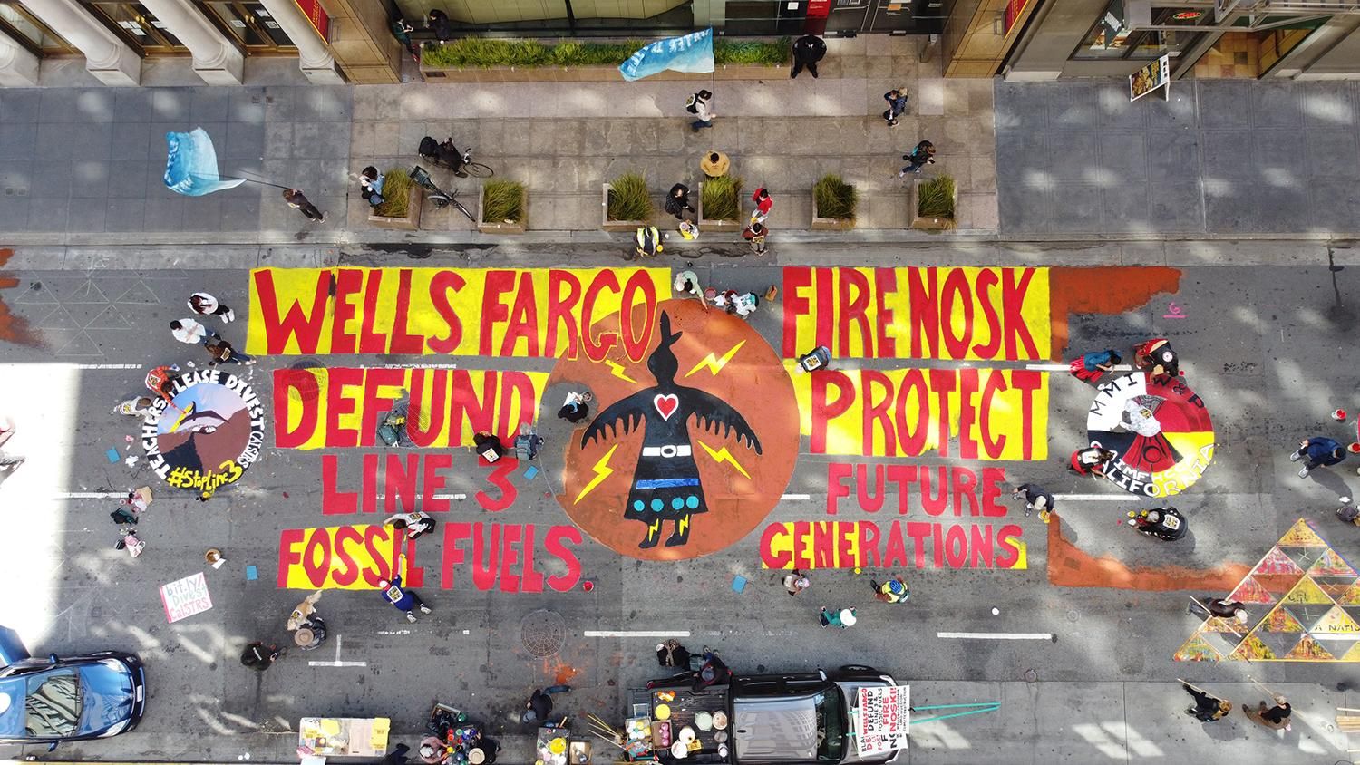 On Friday, hundreds of activists in San Francisco painted the street outside of Wells Fargo’s headquarters, urging the bank to both stop funding Line 3, and remove Noski from the head of the bank. (Photo: Arthur Koch)