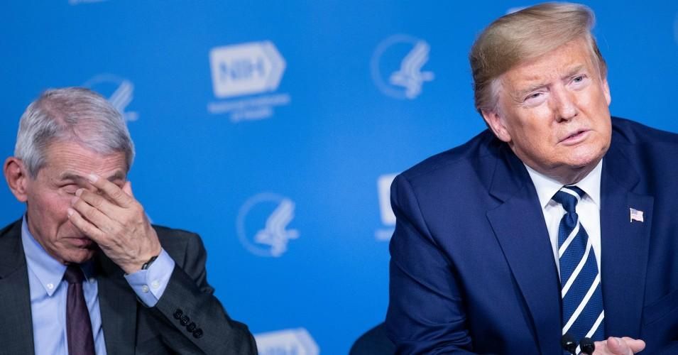 President Donald Trump looks on next to Anthony Fauci, director of the NIH National Institute of Allergy and Infectious Diseases