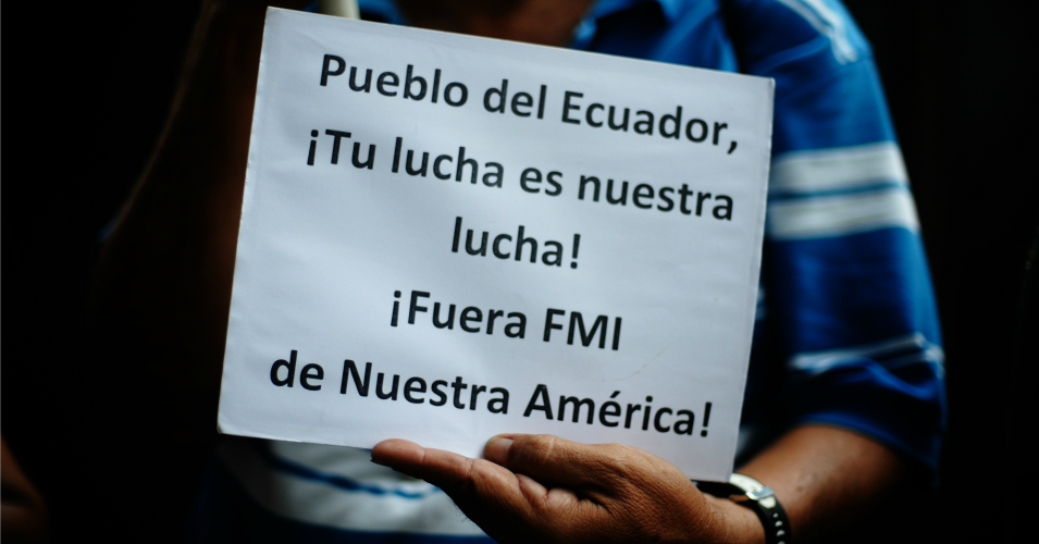  A man holds a sign against the International Monetary Fund during a demonstration in solidarity with Ecuadorian people at the Embassy of Ecuador on October 14, 2019 in San Salvador, El Salvador. (Photo by Camilo Freedman/APHOTOGRAFIA/Getty Images)