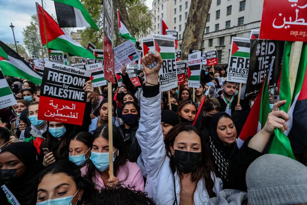 Pro-Palestinian people chant "Free Palestine" while they are holding banners and placards outside Downing Street during a "Save Sheikh Jarrah" demonstration in central London on Tuesday, May 11, 2021. At least 24 Palestinians were killed Monday in Israeli air raids on the besieged Gaza Strip. (Photo: Vudi Xhymshiti/Anadolu Agency via Getty Images)