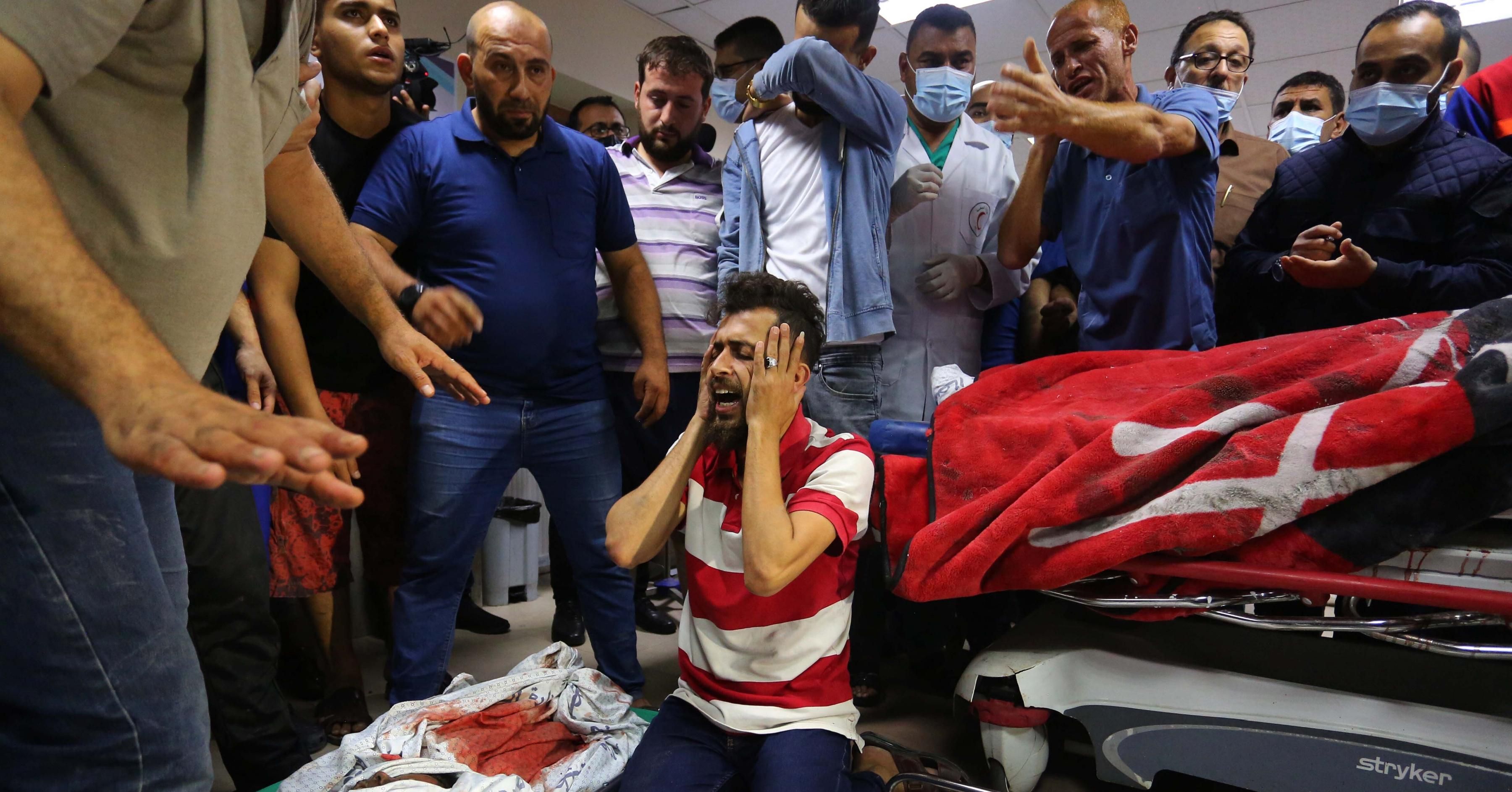 (EDITOR'S NOTE: Image depicts death) Relatives mourn next to the bodies who were killed in Israeli attack carried out to home of Palestinian Abu Khatab Family living in Al-Shati Camp in Gaza Strip, at the morgue of Shifa Hospital on May 15, 2021, in Gaza City, Gaza. 7 people, including 5 children, 2 women killed in Israeli attack on Gaza Strip. (Photo: Ashraf Amra/Anadolu Agency via Getty Images)