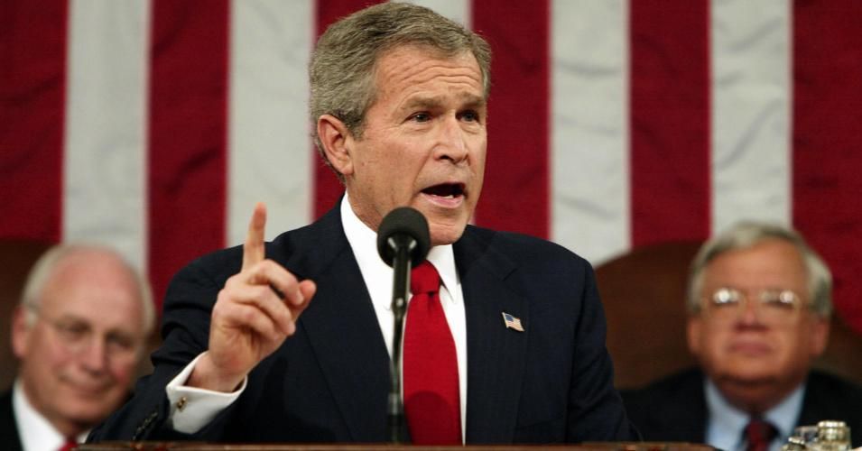 US President George Bush addresses the nation during his State of the Union address from Capitol Hill in Washington 20 January 2004. Bush vowed that the United States "will never seek a permission slip" to go to war as he took aim in his annual State of the Union speech at critics of the invasion of Iraq. At left is Vice President Dick Cheney; at right House Speaker Dennis Hastert, R-IL. (Photo: Kevin Lamarque/AFP/Getty Images)