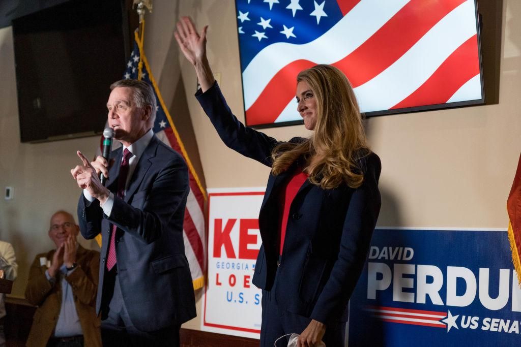U.S. Sen David Perdue (R-GA) and Sen Kelly Loeffler (R-GA) speaks at a campaign event to supporters at a restaurant on November 13, 2020 in Cumming, Georgia. There is a runoff election between Loeffler and Democratic opponent Raphael Warnock scheduled for Jan. 5, along with a second Senate runoff between Republican incumbent David Perdue and Democratic challenger Jon Ossoff. (Photo by Megan Varner/Getty Images).
