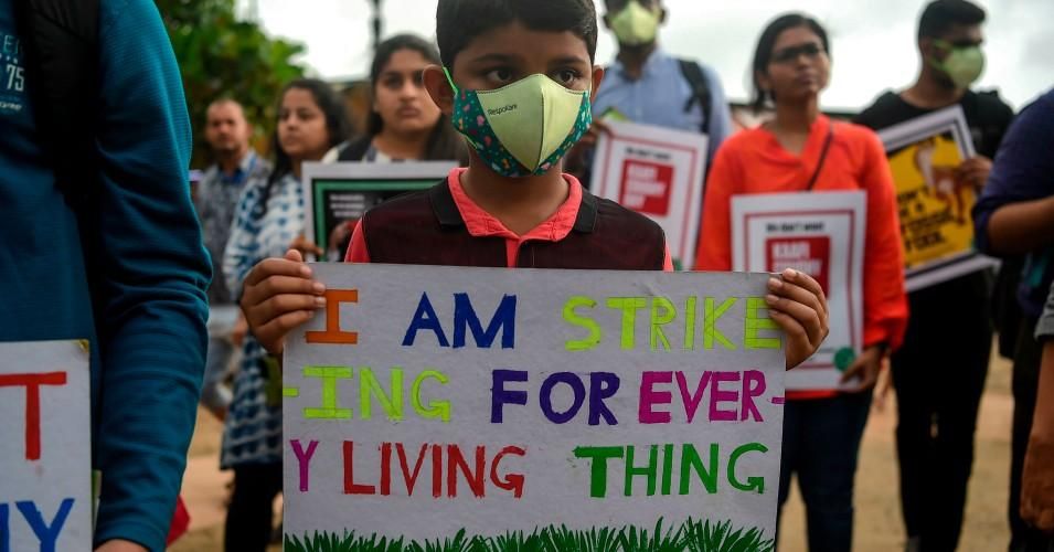 A boy holds a poster as he participates in a protest against governmental inaction towards climate breakdown and environmental pollution, part of the Fridays for Future demonstrations in Mumbai, India on Sept. 20, 2019. (Photo: Punit Paranjpe/AFP/Getty Images)