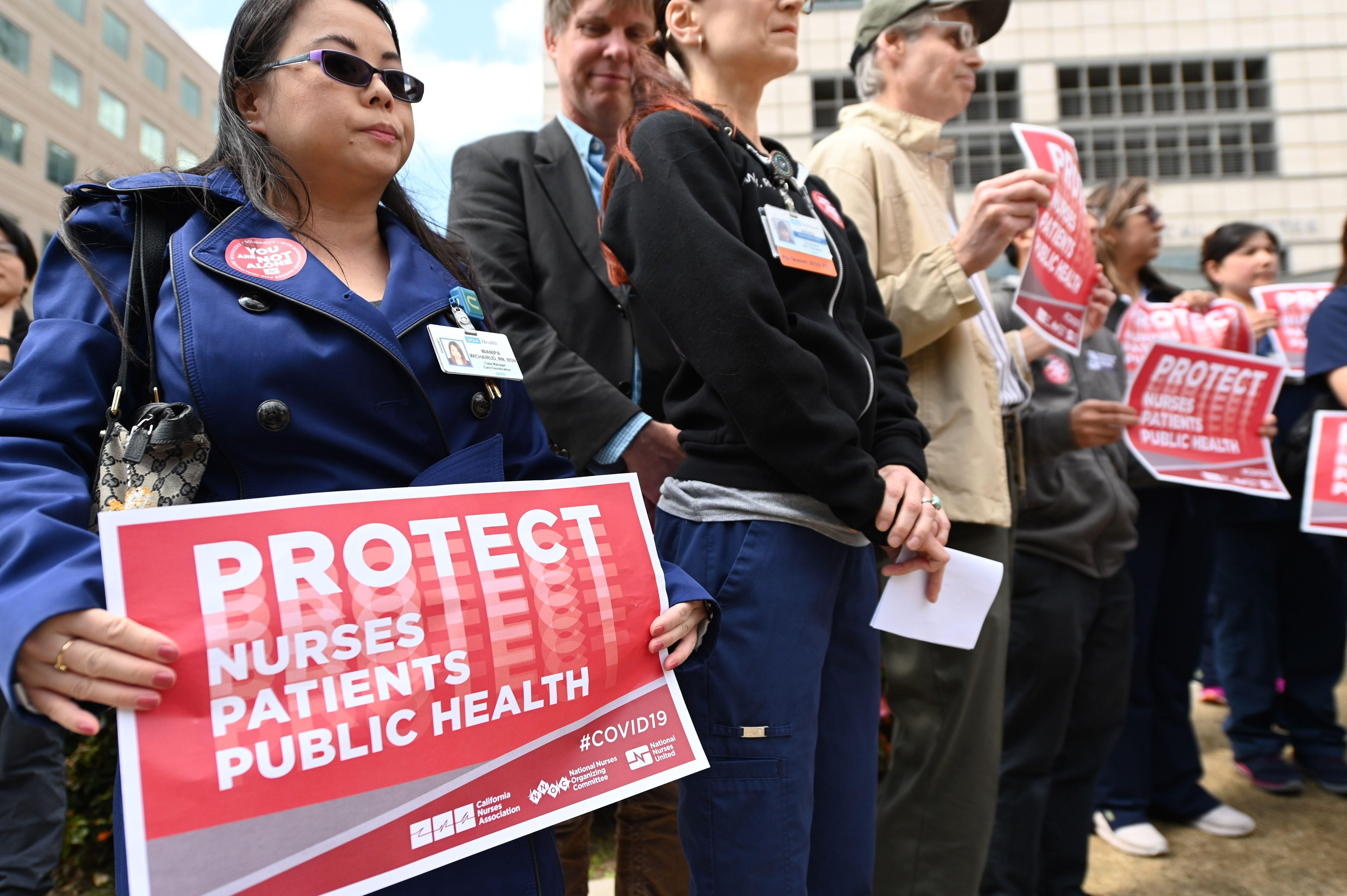 Nurses protest to oppose what they call the Center for Disease Control's (CDC) weak response to the novel coronavirus, COVID-19 pandemic, March 11, 2020 outside the UCLA Medical Center in Los Angeles, California. (Photo by ROBYN BECK/AFP via Getty Images)