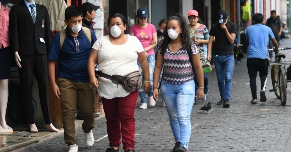 People wear face masks as a preventive measure against the spread of the new coronavirus, COVID-19, in Guatemala City, on March 16, 2020. (Photo: Johan Ordonez/AFP via Getty Images)