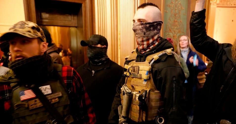 Protestors try to enter the Michigan House of Representative chamber and are being kept out by the Michigan State Police. (Photo: Jeff Kowalsky/AFP via Getty Images)