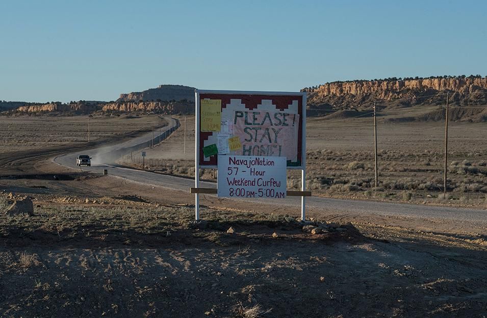 A sign asking Navajo residents to stay safe and warning of a curfew near the Navajo Nation town of Casamero Lake in New Mexico on May 20, 2020. - The Navajo Nation now has the highest per capita COVID-19 infection rate in the country after surpassing New York.