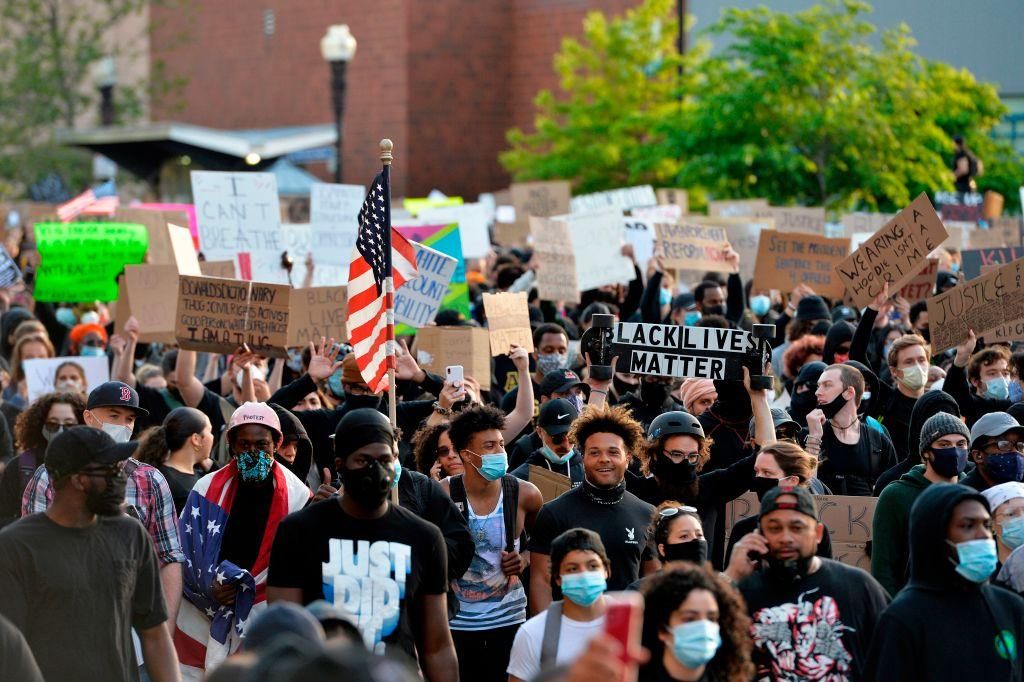 Protesters hold up signs as they march during a demonstration over the death of George Floyd, an unarmed black man who died in Minneapolis Police custody, in Boston, Massachusetts on May 31, 2020. (Photo: JOSEPH PREZIOSO/AFP via Getty Images)