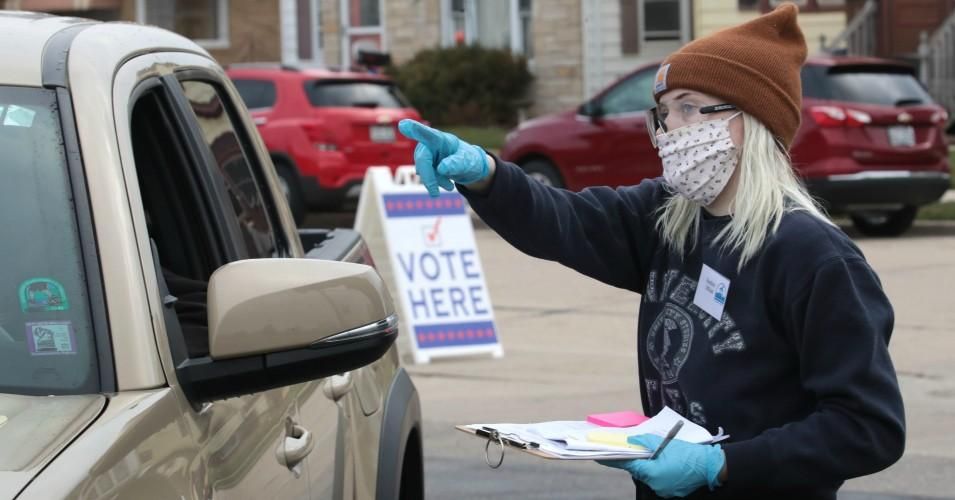 An election official checks in a resident at a drive-up polling place set up outside of Roosevelt Elementary School on April 7, 2020 in Racine, Wisconsin. (Photo: Scott Olson/Getty Images)