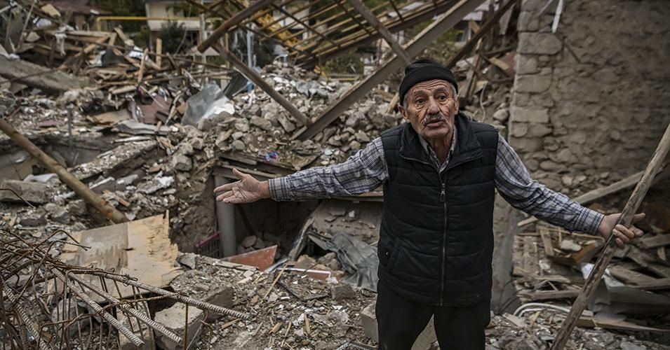 Retired police officer Genadiy Avanesyan, 73, searches for belongings in the remains of his house, which is said was destroyed by Azeri shelling, in the city of Stepanakert on October 10, 2020