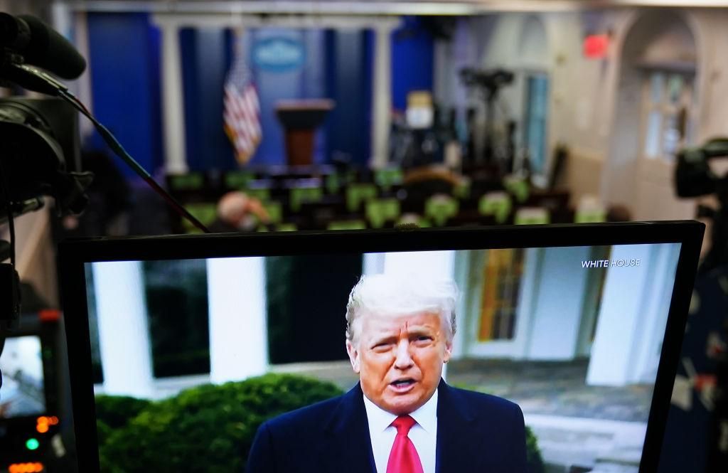 US President Donald Trump is seen on TV from a video message released on Twitter addressing rioter at the US Capitol, in the Brady Briefing Room at the White House in Washington, DC, on January 6, 2021. Trump told his supporters on Wednesday to "go home" after they stormed the US Capitol following a rally during which he repeated his spurious claims of election fraud. (Photo by MANDEL NGAN/AFP via Getty Images)