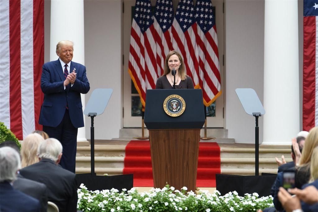 Amy Coney Barrett (R), U.S. President Donald Trump's nominee for associate justice of the U.S. Supreme Court, speaks as U.S. President Donald Trump listens during an announcement ceremony at the White House on September 26, 2020 in Washington, DC. (Photo by Chen Mengtong/China News Service via Getty Images)