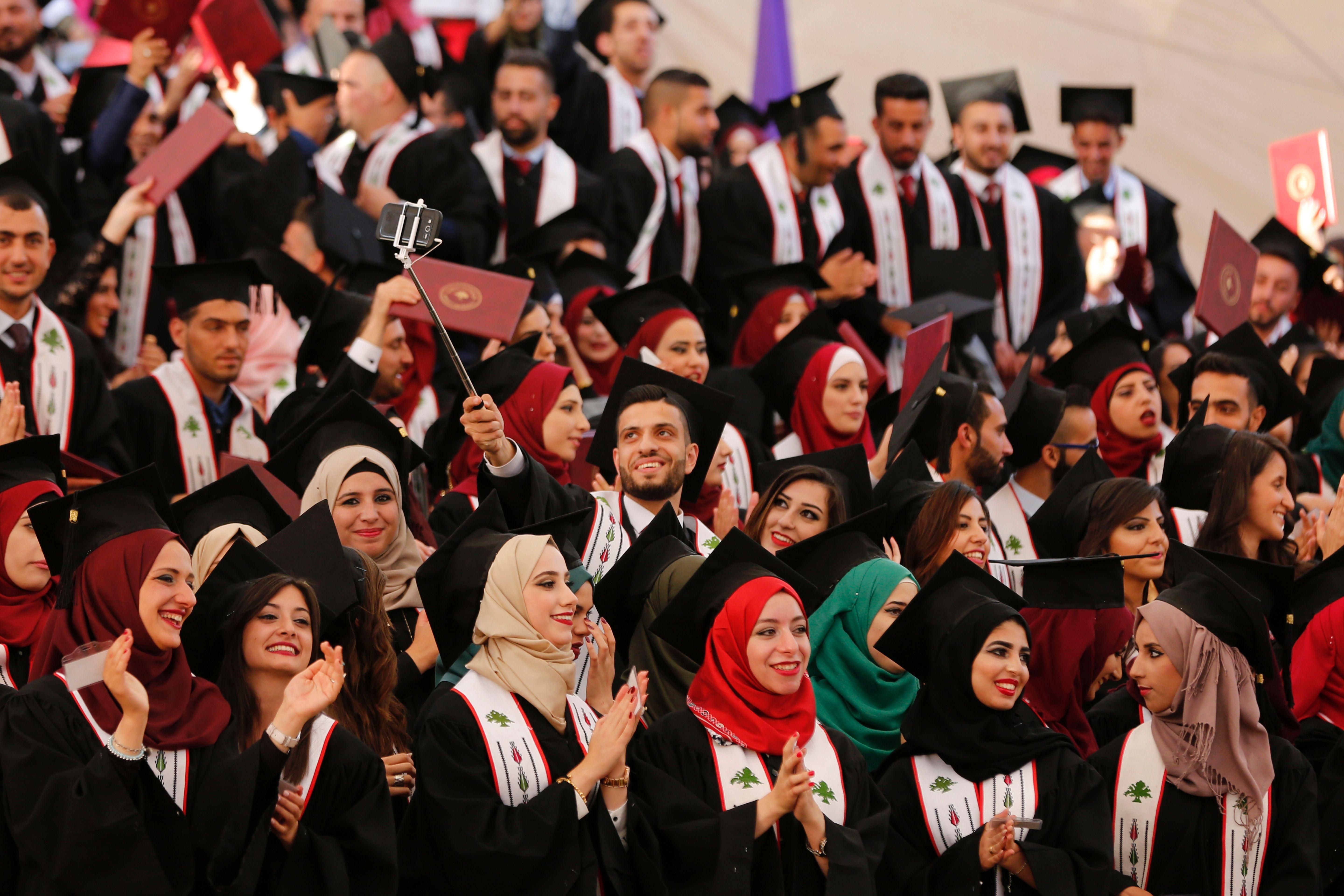 A Palestinian student takes a selfie during his graduation ceremony at the end of the academic year on May 20, 2016 at Birzeit University in the West Bank town of Birzeit, near Ramallah. / AFP / ABBAS MOMANI (Photo credit should read ABBAS MOMANI/AFP/Getty Images)