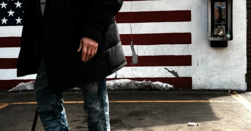 A man walks through an impoverished area of Worcester, Massachusetts on March 20, 2018.