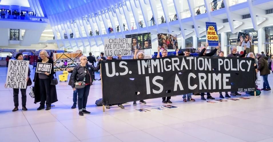 Protesters holding a banner reading, "U.S. Immigration Policy Is A Crime" at a silent protest in January 2020. 