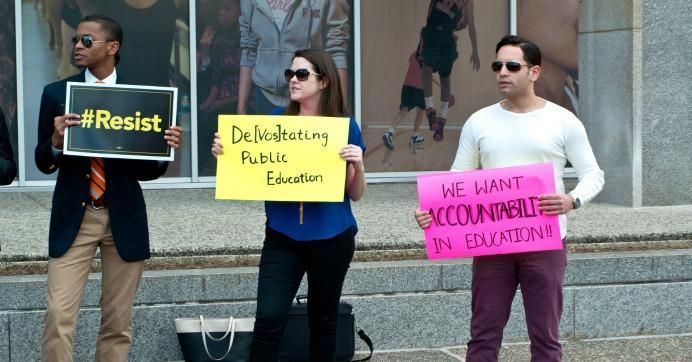 Demonstrators hold signs outside the Dept. of Education on Feb. 9, 2017. (Photo: majunznk/flickr/cc)
