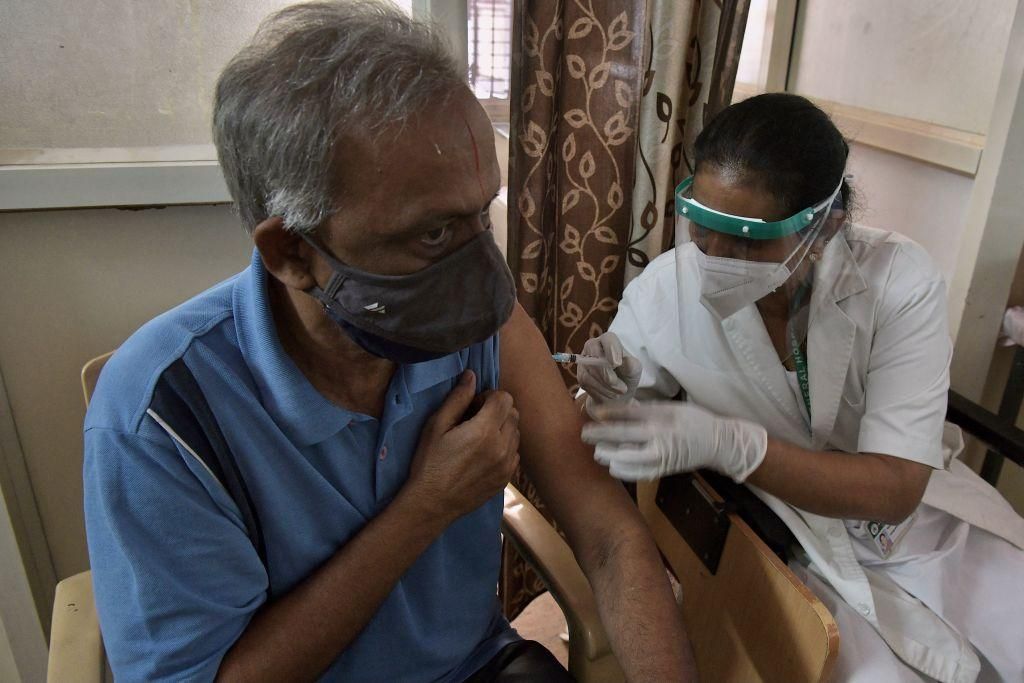 A medical worker inoculates a man with a dose of the Covaxin Covid-19 coronavirus vaccine at a vaccination centre in KC General government hospital in Bangalore on May 7, 2021. (Photo: Manjunath Kiran / AFP/Getty Images)