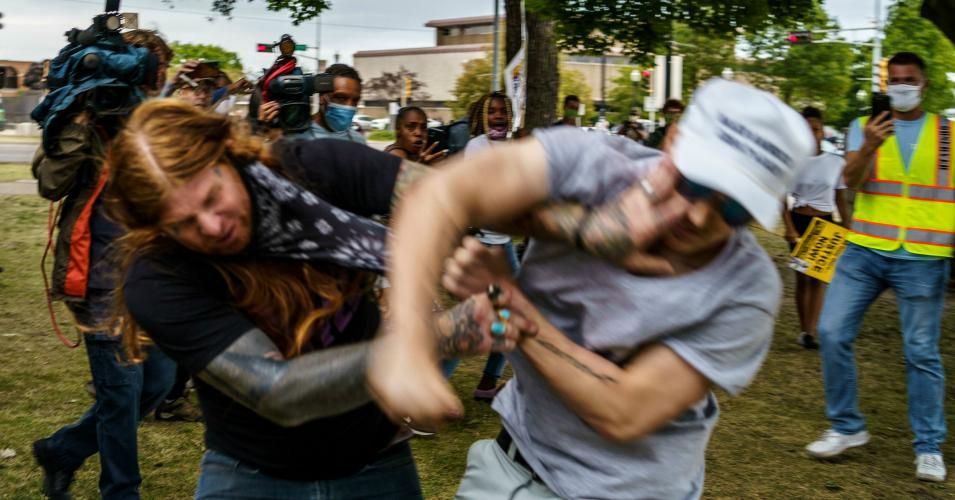 A protester scuffles with a Trump supporter (R) in Kenosha, Wisconsin, on September 1, 2020, amid ongoing demonstrations after the shooting by police of Jacob Blake. President Donald Trump on September 1 took his so-called "tough law and order" message to Kenosha, the latest US city roiled by the police shooting of a black man, as he branded recent anti-racism protests acts of "domestic terror" by violent mobs. (Photo:Kerem Yucel/AFP via Getty Images)