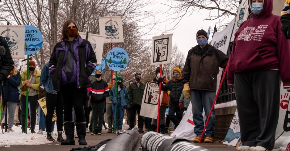 People protest against the Enbridge Energy Line 3 oil pipeline project outside the Governor's Mansion in St. Paul, Minnesota on November 14, 2020. Increasingly, corporate-funded politicians are criminalizing efforts to roll back the harms fossil fuel interests are doing to vulnerable communities. (Photo: Stephen Maturen/Getty Images)