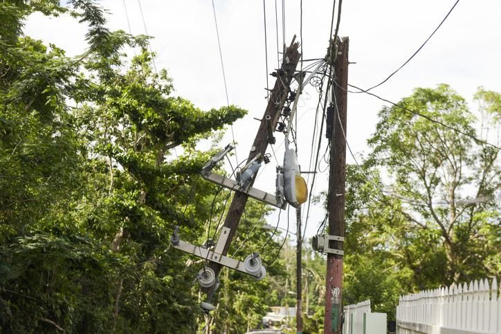 Dangerous power lines and power pole dangle over street traffic in Vega Alta, Puerto Rico after Hurricane Maria. (Photo: Getty/Stock Photo/alejandrophotography)