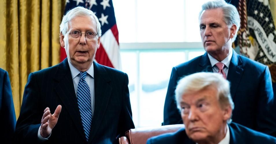 Senate Majority Leader Mitch McConnell (R-Ky.) speaks as House Minority Leader Kevin McCarthy (R-Calif.) and President Donald Trump listen during a signing ceremony in the Oval Office of the White House on March 27, 2020 in Washington, D.C. (Photo: Erin Schaff-Pool/Getty Images)