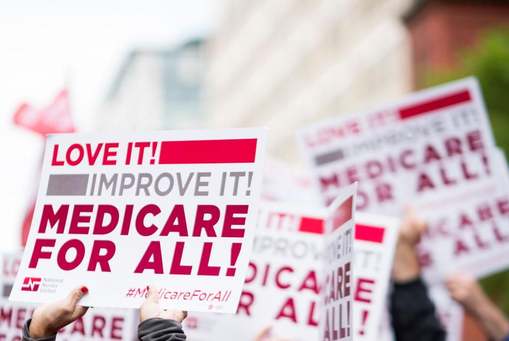 Members of National Nurses United union members wave "Medicare for All" signs during a rally in front of the Pharmaceutical Research and Manufacturers of America in Washington calling for "Medicare for All" on Monday, April 29, 2019. (Photo By Bill Clark/CQ Roll Call)