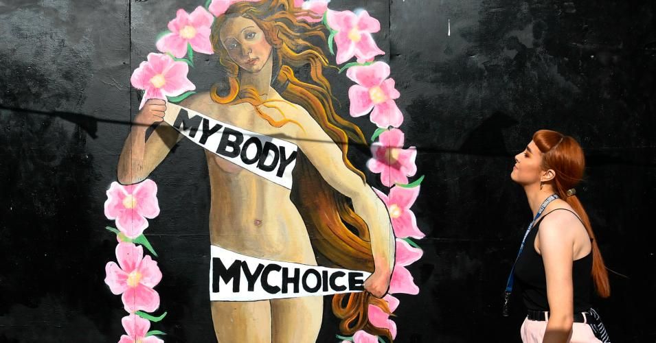 A woman walks in front of a pro-choice mural relating to the laws regarding abortion in Dublin on May 11, 2018 ahead of a national referendum (Photo: Artur Widak/AFP/Getty Images)