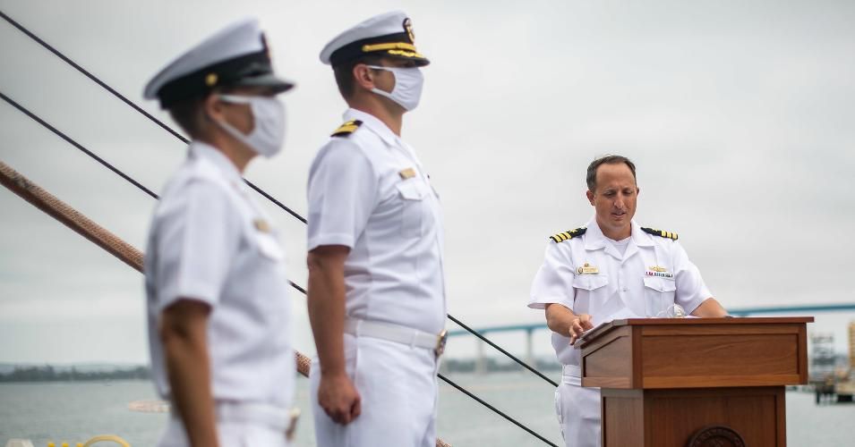 Cmdr. R.J. Zamberlan, the commanding officer of the Navy's newest littoral combat ship, USS Kansas City (LCS 22), reads his orders during the ship’s commissioning ceremony on June 20, 2020 in San Diego, California. (Photo: US Navy/Mass Communication Specialist 2nd Class Alex Corona)