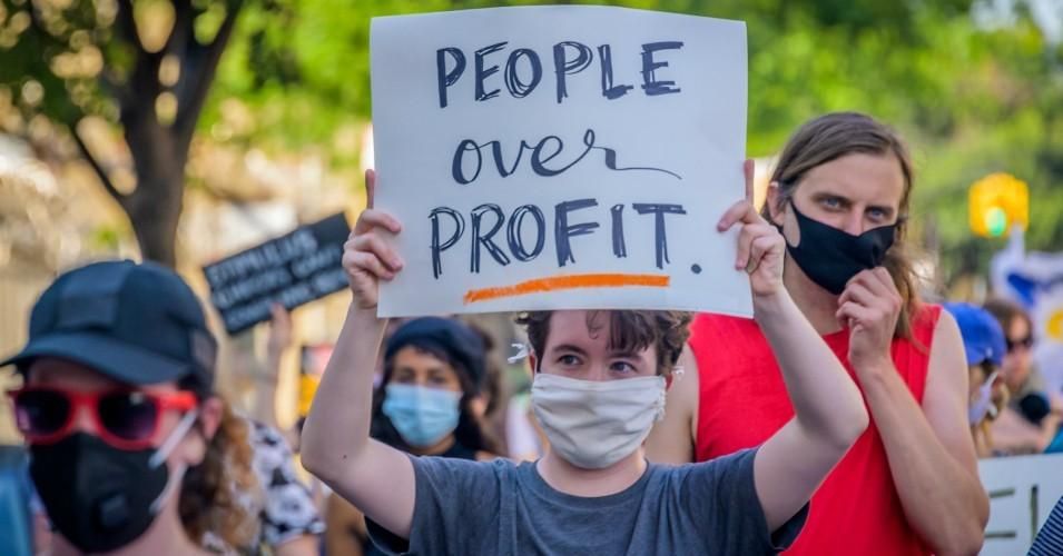 A demonstrator holding a "People Over Profit" sign at a protest in Brooklyn on June 5, 2020.