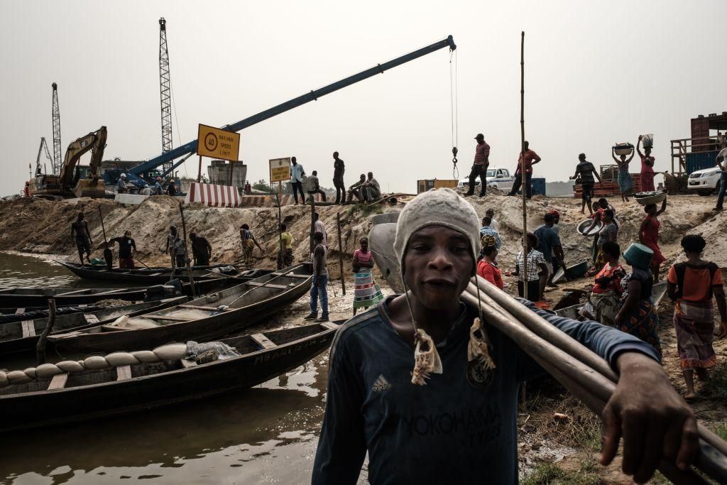 A fisherman carry paddles as he returns from overnight fishing at the River Bodo, which was damaged by the devastating oil spills from the pipeline about 10 years ago in Bodo village of Ogoniland, which is part of the Niger Delta region, Nigeria, on Feburuary 19, 2019. (Photo: YASUYOSHI CHIBA/AFP via Getty Images)
