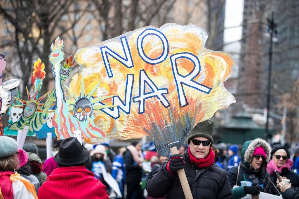 A marcher holds a sign that says "NO WAR" as they wait to start marching past Trump International Tower during the Woman's March in the borough of Manhattan in NY on January 18, 2020, USA. (Photo by Ira L. Black/Corbis via Getty Images)